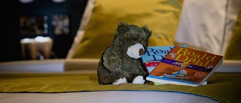 A bed with a plush toy and a book titled 'The Miracle of the Little Duck'.
