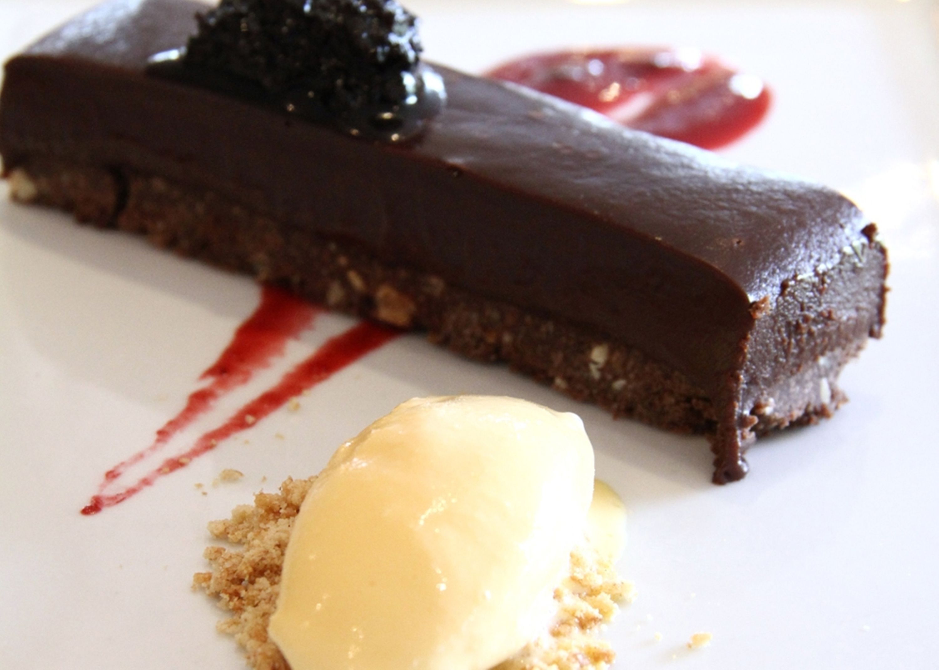A dessert with chocolate and berries on a plate.