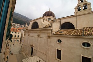A historic building with a dome, arched windows, and a bell tower.