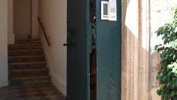 A staircase leading to an apartment with a sign indicating it is an apartment.