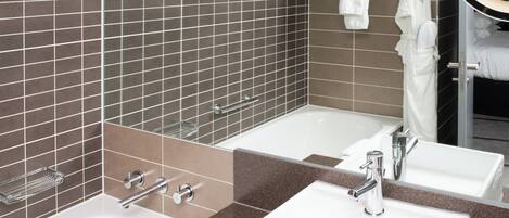 A bathroom with two sinks, a mirror, and a towel rack.