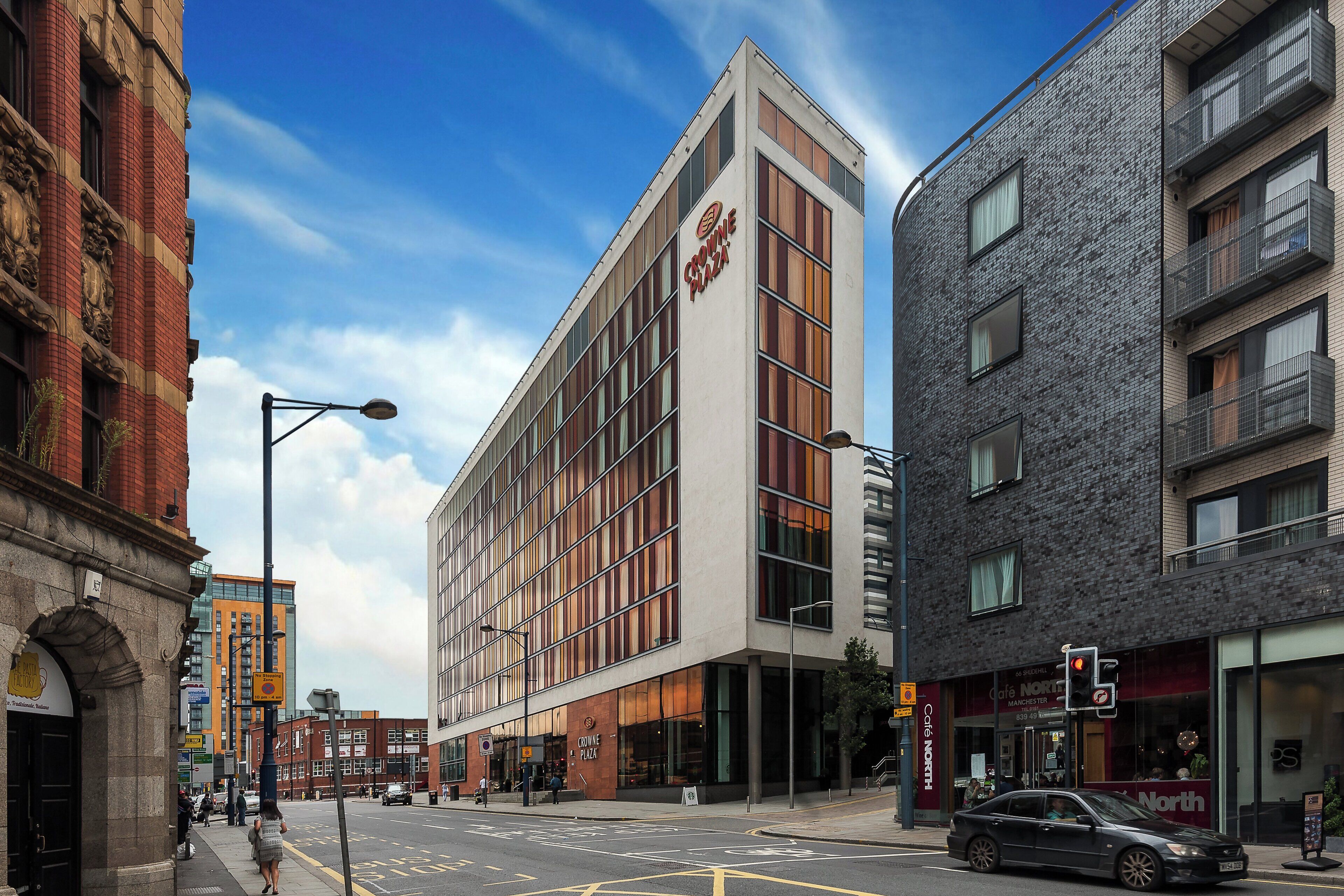A modern building with a prominent sign for Crowne Plaza.