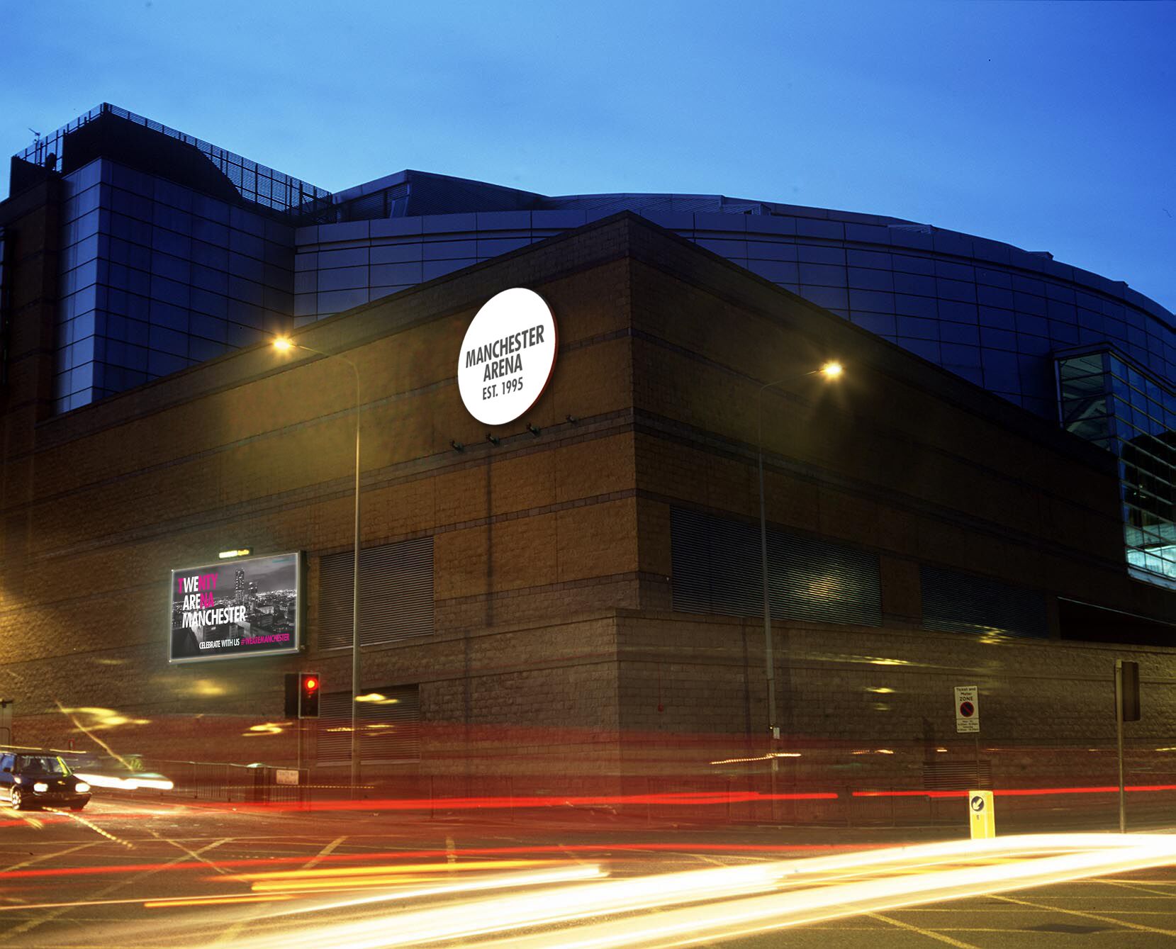 A modern building with a prominent sign reading "Manchester Arena Est. 1995".
