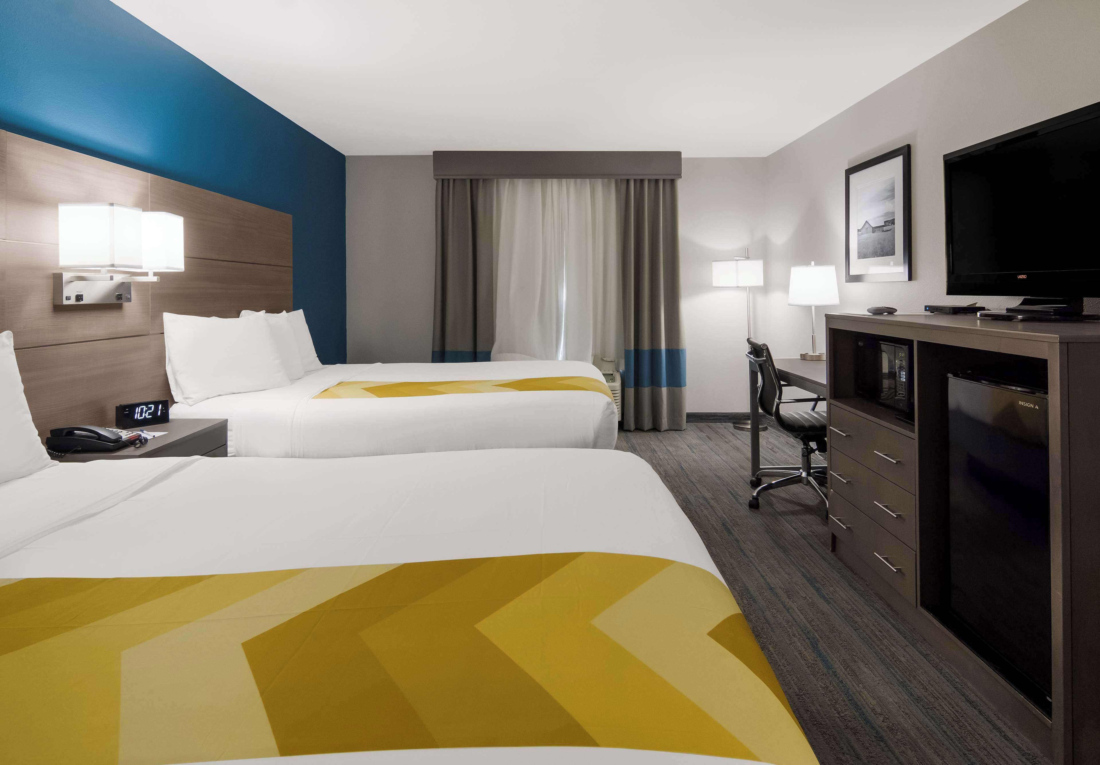 suite, 2 queen beds, non smoking, refrigerator & microwave (with single sofabed) | in-room safe, desk, iron/ironing board, free cots/infant beds