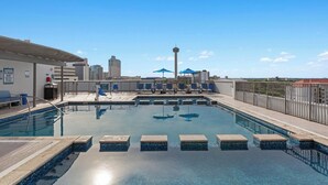 A rooftop swimming pool with clear blue water, lounge chairs, and umbrellas. - Club Wyndham La Cascada (San Antonio)