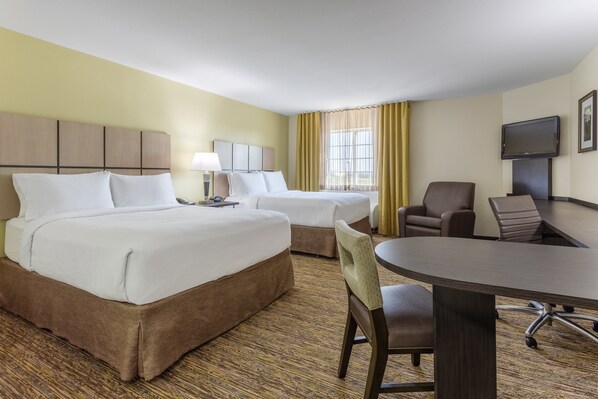 A hotel room with two beds, a desk, a chair, a television, and a window with curtains. - Candlewood Suites Aurora-Naperville by IHG (Aurora)