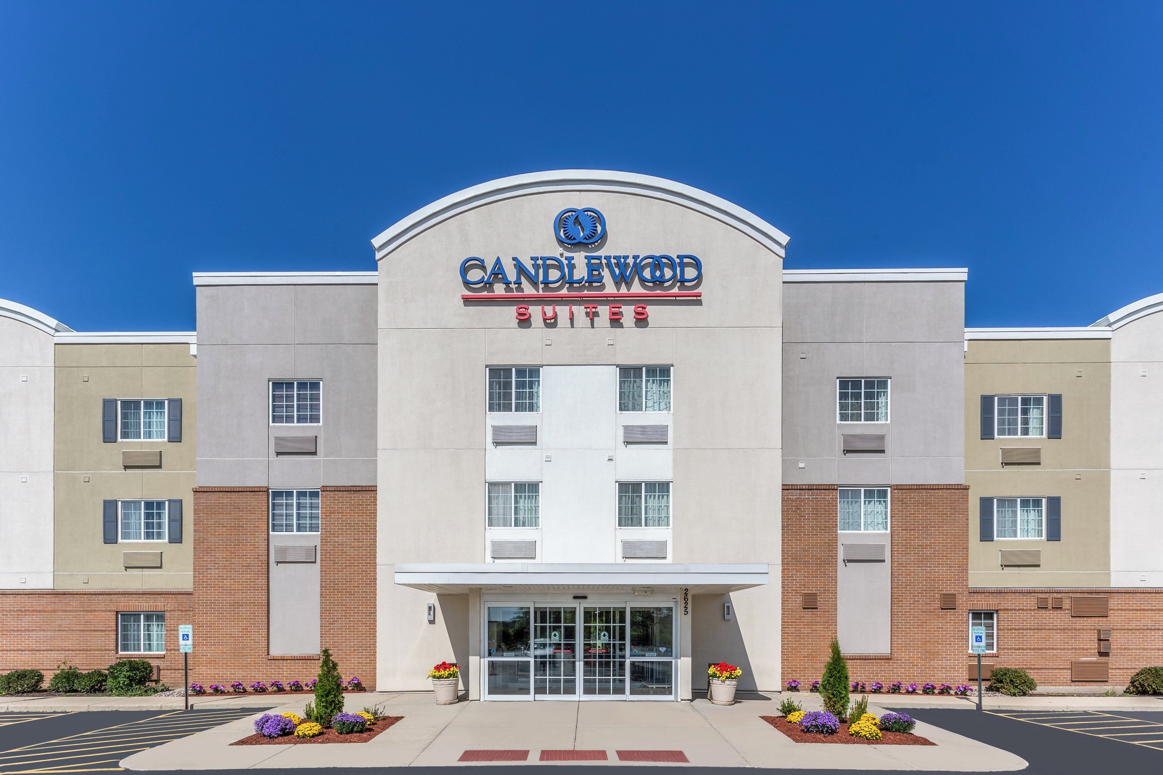 A hotel with a modern facade, a prominent entrance, and a clear sky above.
