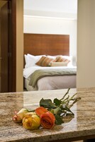 Un bouquet de roses posé sur un comptoir en granit, dans une chambre d’hôtel.