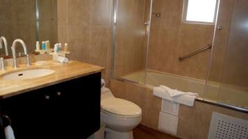 A modern bathroom with a sink, toilet, and shower.