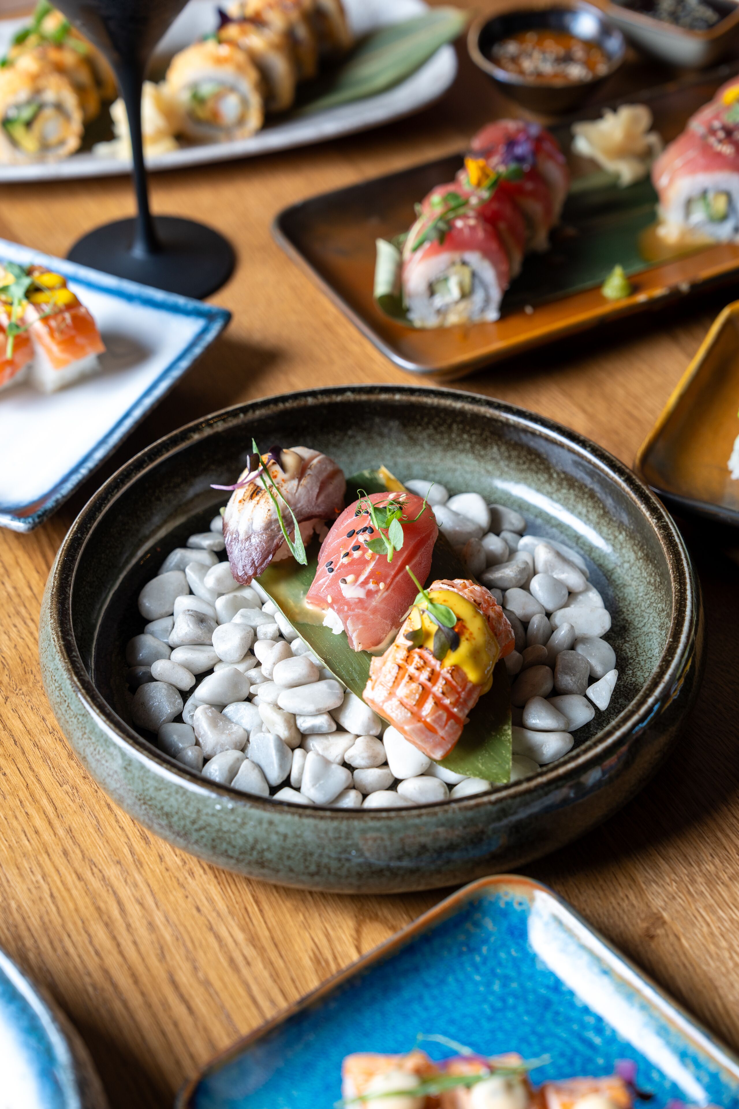 A dining table with various sushi dishes.