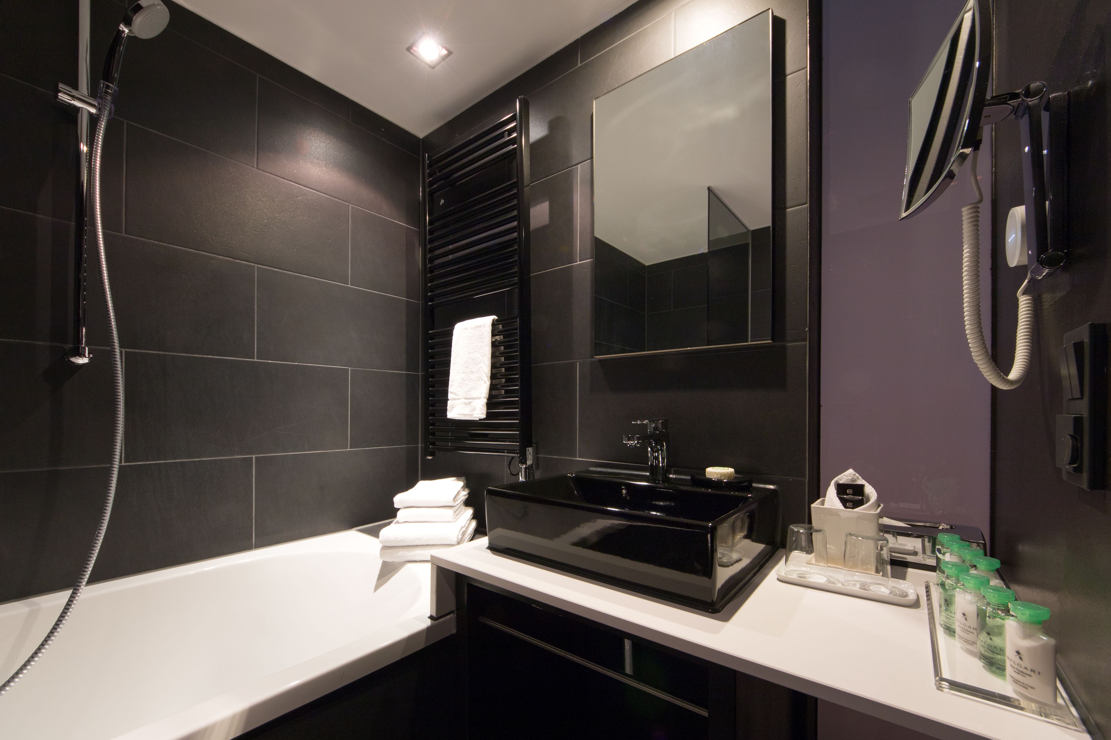 deep-soaking bathtub, designer toiletries, hair dryer, slippers