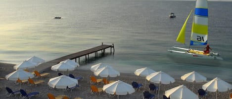 On the beach, sun loungers, beach umbrellas, water skiing