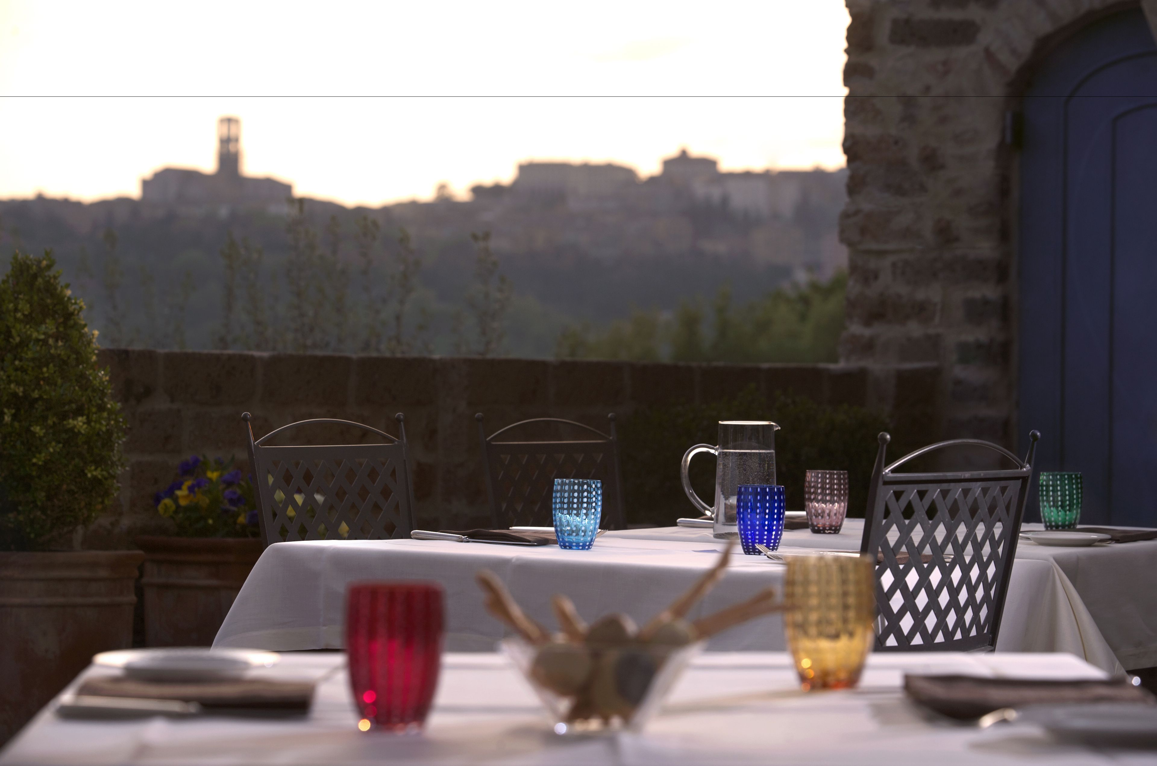 A table set for dining with a view of a historic building in the background.
