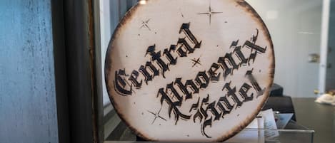 A circular sign with the text 'Central Phoenix Hotel' in a decorative font.