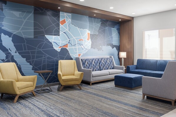 A lobby with a large map mural, two armchairs, a sofa, and a side table. - Holiday Inn Express &Suites Snyder by IHG (Snyder)