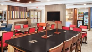 A modern restaurant with a large dining area, red chairs, and a flat-screen TV. - Holiday Inn Express Haskell - Wayne Area by IHG (Wanaque)
