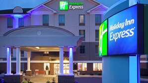 A Holiday Inn Express building with a prominent sign, a covered entrance, and a brick facade. - Holiday Inn Express Haskell - Wayne Area by IHG (Wanaque)