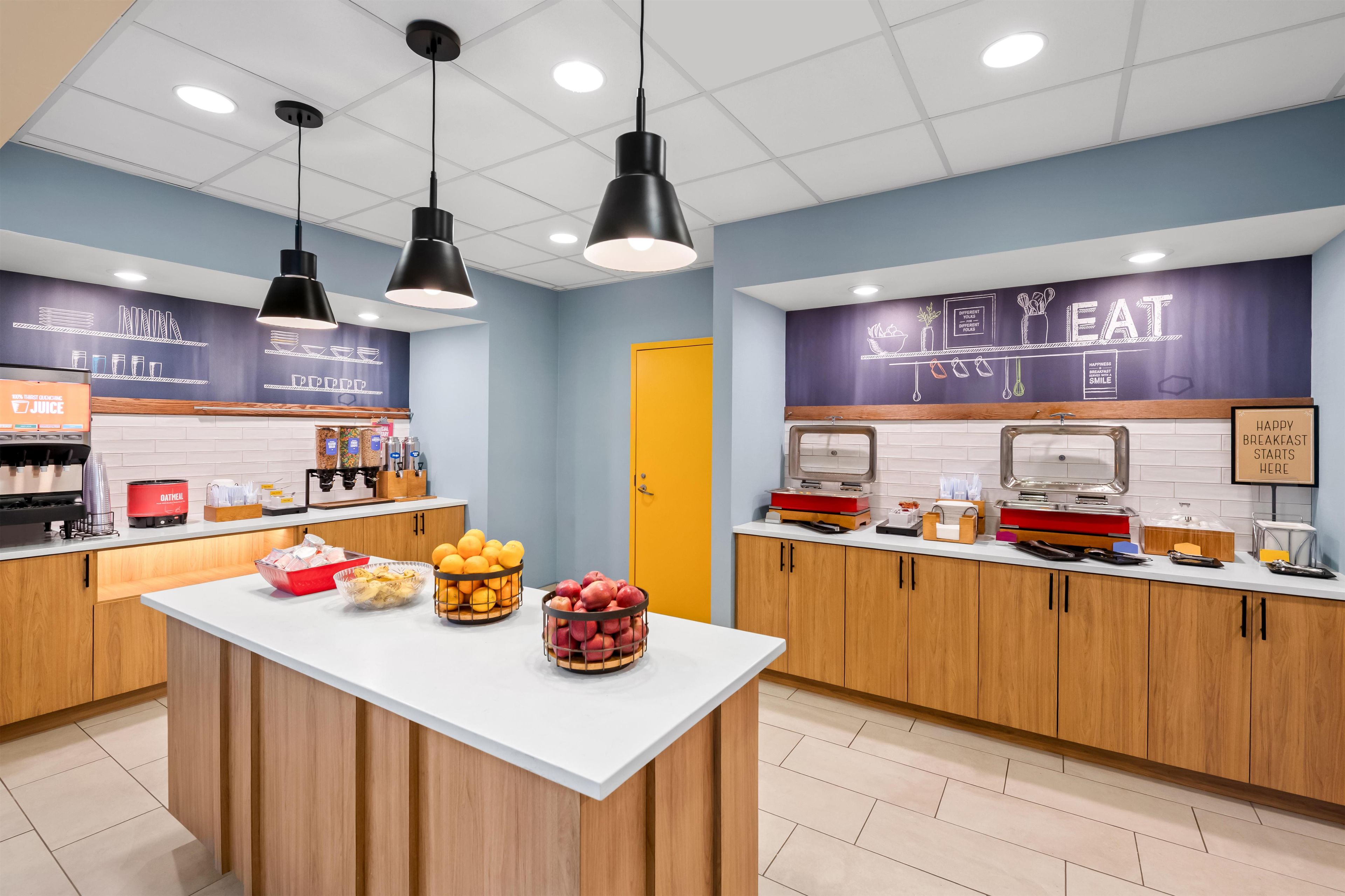 A breakfast bar with a variety of food items and a coffee machine.