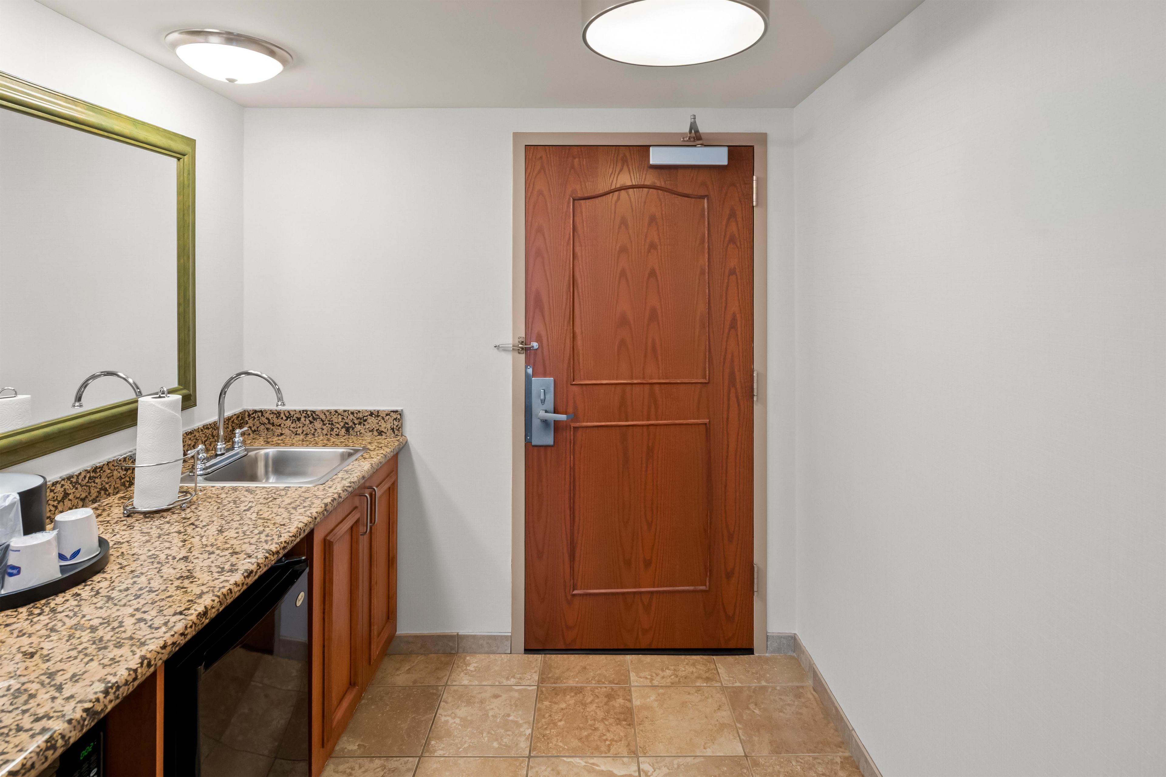 A bathroom with a sink, mirror, and toilet.