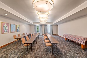 A conference room with long tables, chairs, and a bench. - Hampton Inn & Suites Williamsburg-Central (Williamsburg)