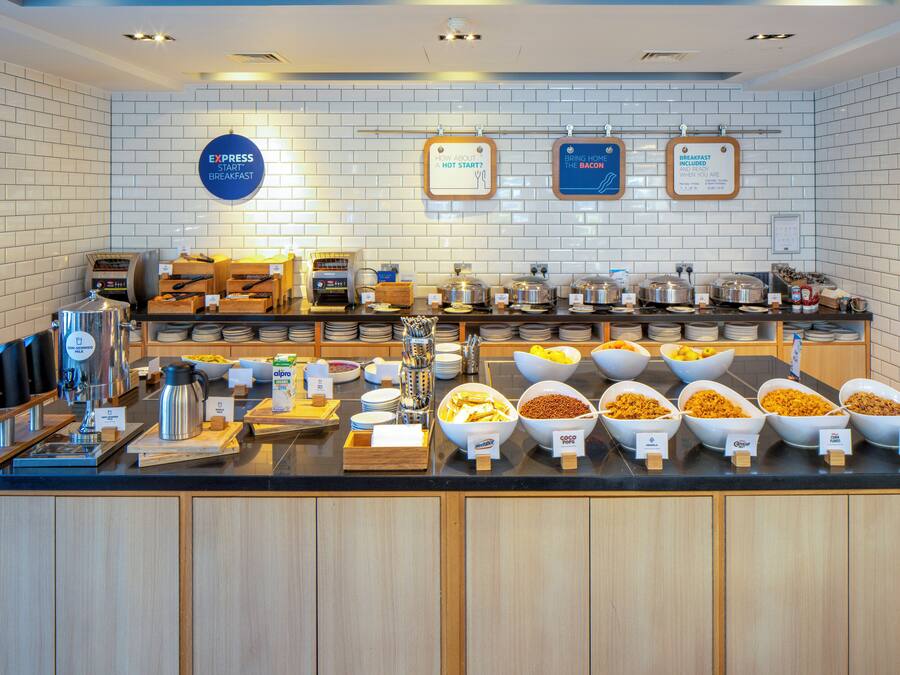 A buffet setup with various food items and a coffee station.