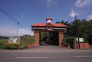 Un bâtiment avec un toit rouge et une tour horloge, portant l’inscription « SAJ KOCH ».