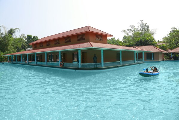A large building with a swimming pool in front. - Saj Earth Resort (Aluva)