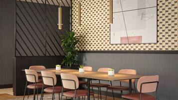 A modern dining area with a wooden table, six chairs, and pendant lights.