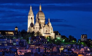 Stunning cathedral with multiple spires and a central dome, set amidst a historic urban landscape.