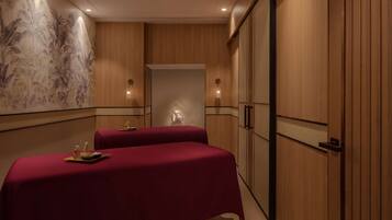 Two beds with comfortable bedding, a tropical mural, and a stylish wardrobe.