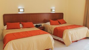 A hotel room with two beds, each with red and beige bedding, and bedside lamps. - Hotel Davimar (Guamuchil)