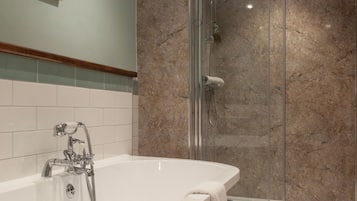 Deluxe Suite, 1 King Bed | Bathroom | Combined shower/tub, hair dryer, towels