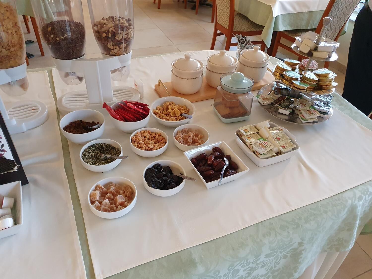 A buffet table with various food items and containers.