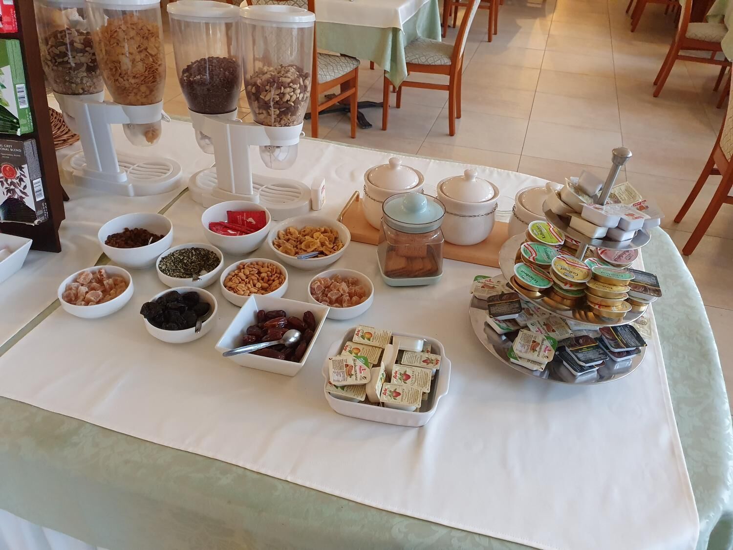 A buffet table with various food items and condiments.