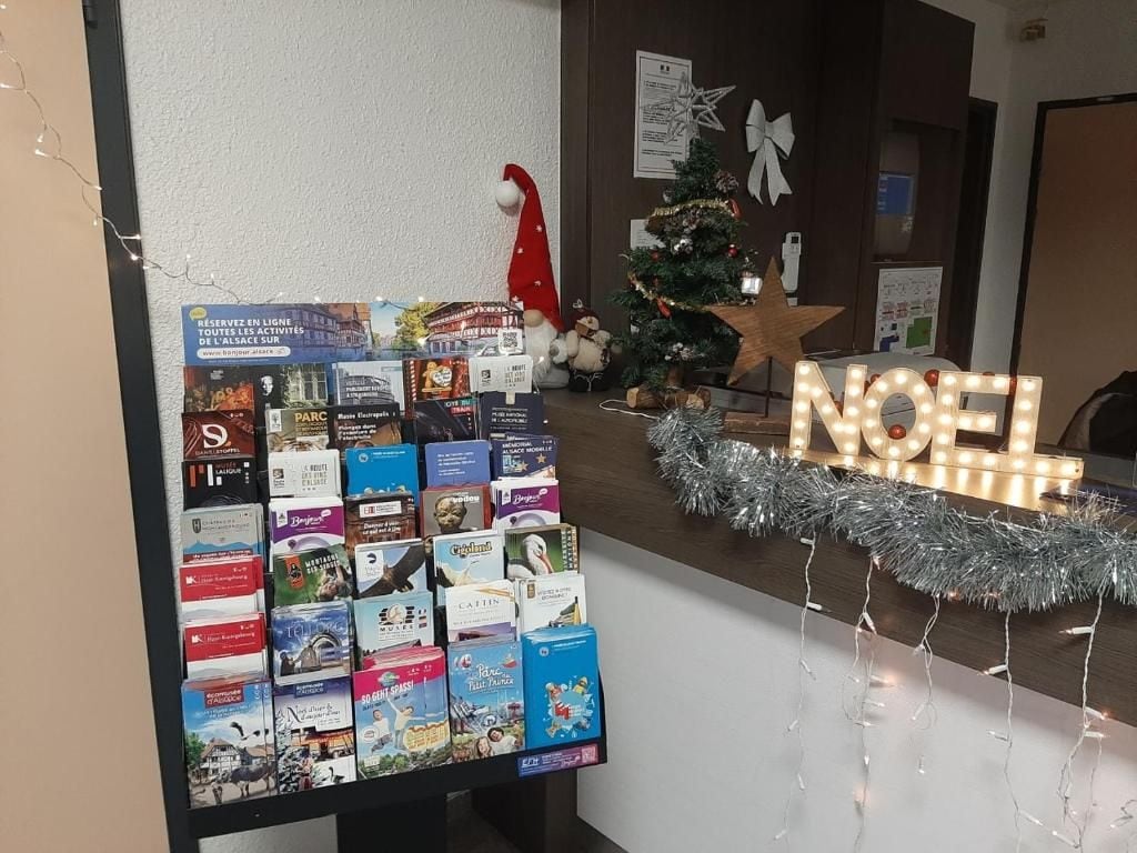 A reception area with a display of books and a Christmas tree.