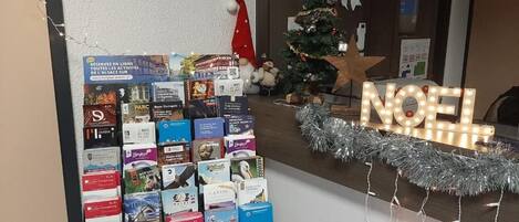 A reception area with a display of books and a Christmas tree.