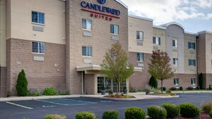 A hotel with a brick facade, multiple windows, and a parking lot. - Candlewood Suites Perrysburg by IHG (Perrysburg)