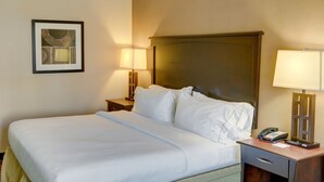 A hotel room with a bed, bedside tables, lamps, and a framed picture on the wall. - Holiday Inn Express Hotel & Suites Huntsville by IHG (Huntsville)