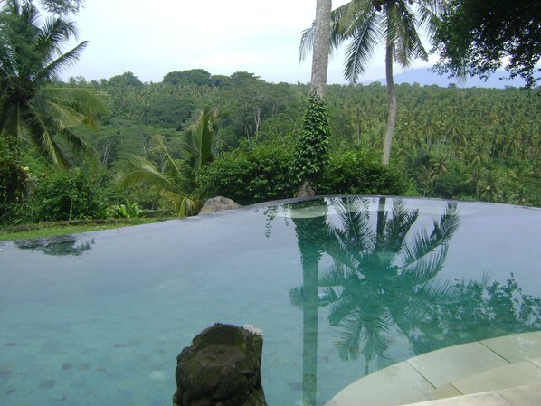 Alberca al aire libre y camastros 