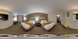 A hotel room with a large bed, a desk, a chair, a small table, and a TV. - Comfort Inn & Suites Midway - Tallahassee West (Midway)