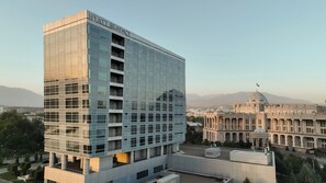 A modern hotel building with a glass facade and a sign reading "HYATT REGENCY".
