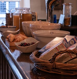 A breakfast buffet with various food items and beverages.