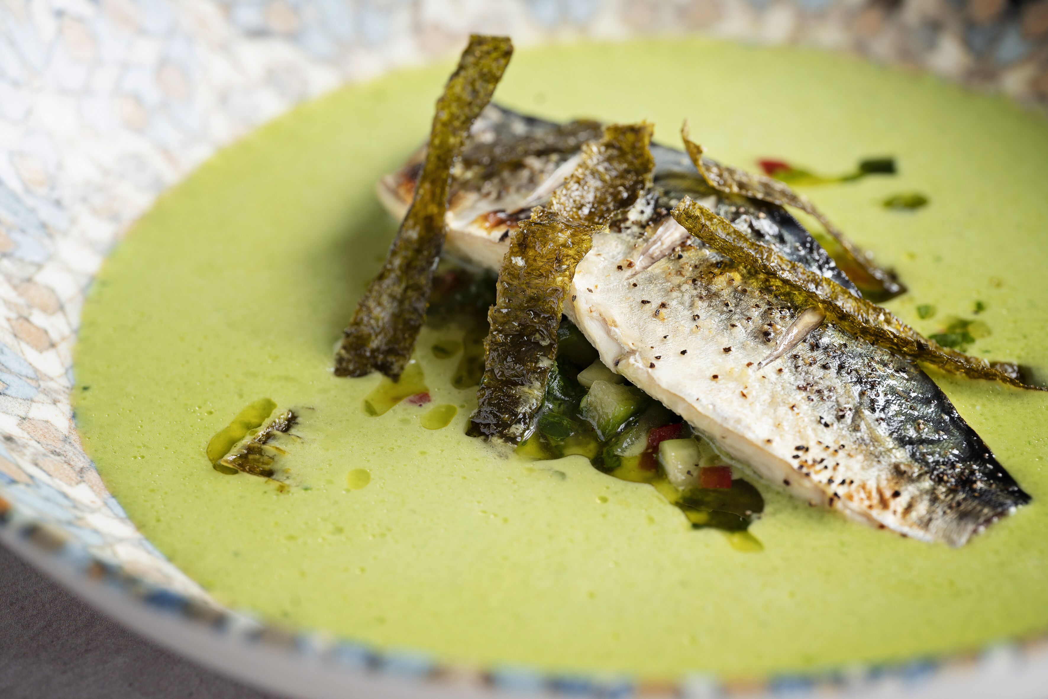 A dish with fish and vegetables in a bowl.