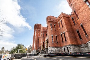 A large brick building with multiple towers and a stone base. - Amsterdam Castle (Amsterdam)