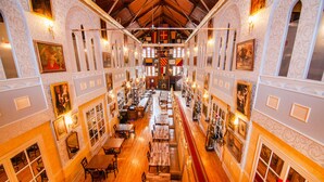 A spacious interior with multiple dining areas, wooden floors, and ornate wall decorations. - Amsterdam Castle (Amsterdam)