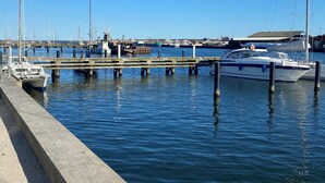 A marina with boats docked at wooden piers. - Teaterhotellet (Horsens)