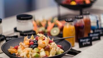 Un buffet de petit-déjeuner proposant une variété de fruits et de boissons.