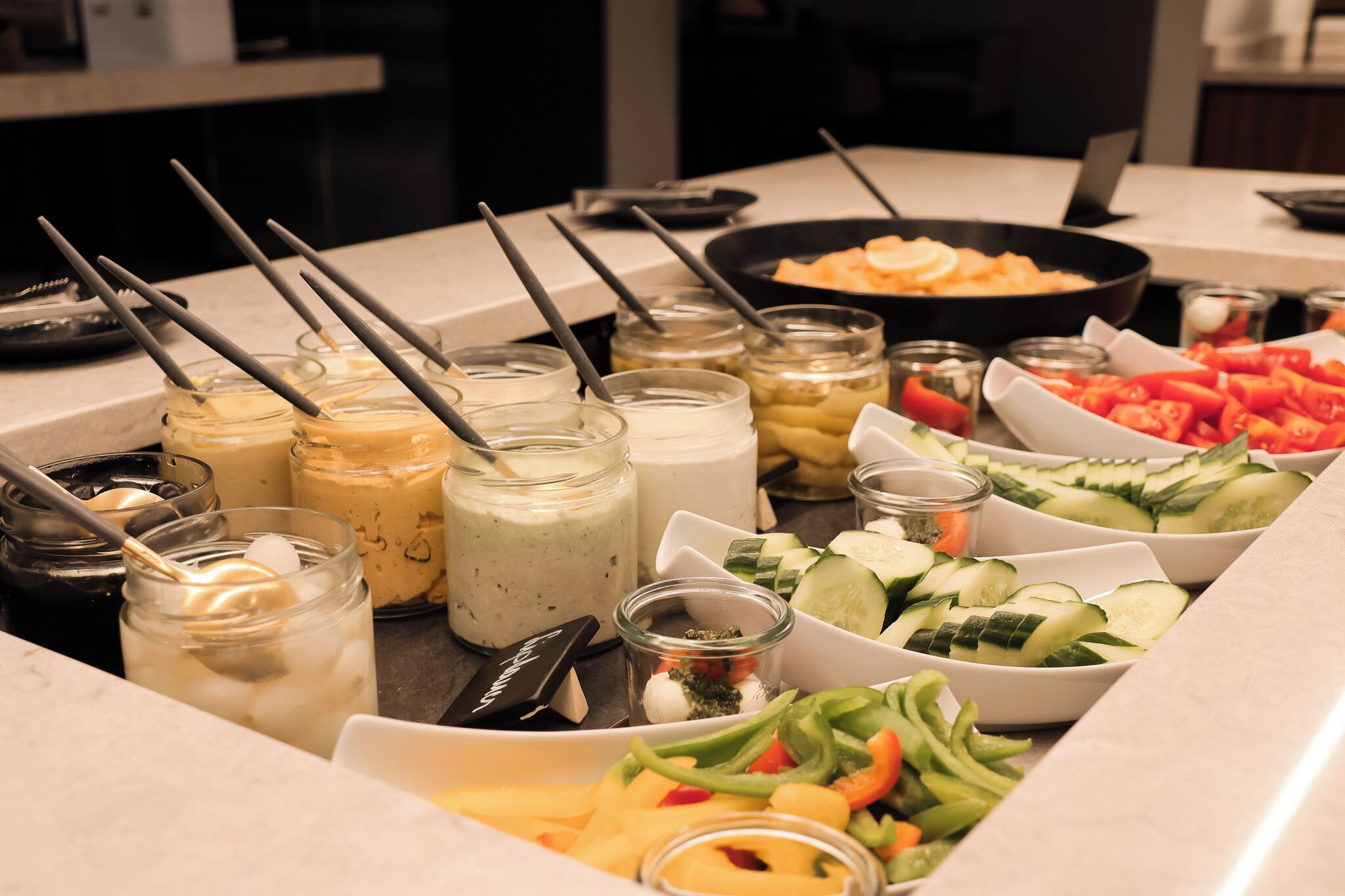 A buffet with various food items and drinks.