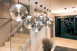 A staircase with a glass railing and a series of spherical mirrors reflecting light. - AlpenParks The Secret Sölden (Soelden)
