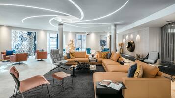 Una sala de estar moderna con un sofá modular, sillones y una mesa de centro.